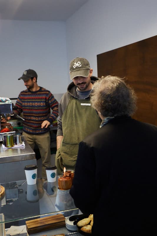 Baristas serving customers